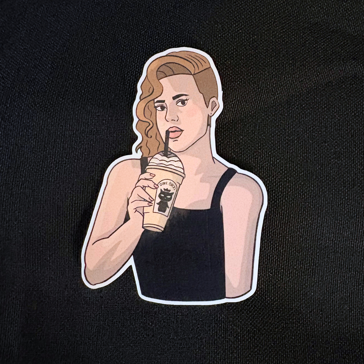 Sticker of woman holding vanilla milkshake with queer coffee shop name. Black background