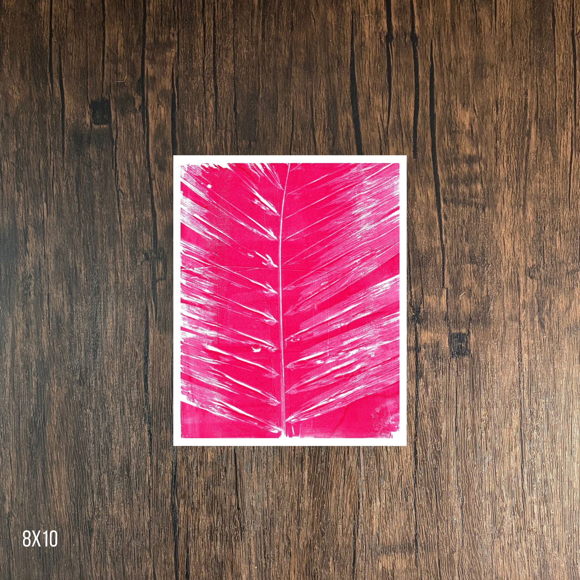 Magenta leaf print on wooden background, 8x10